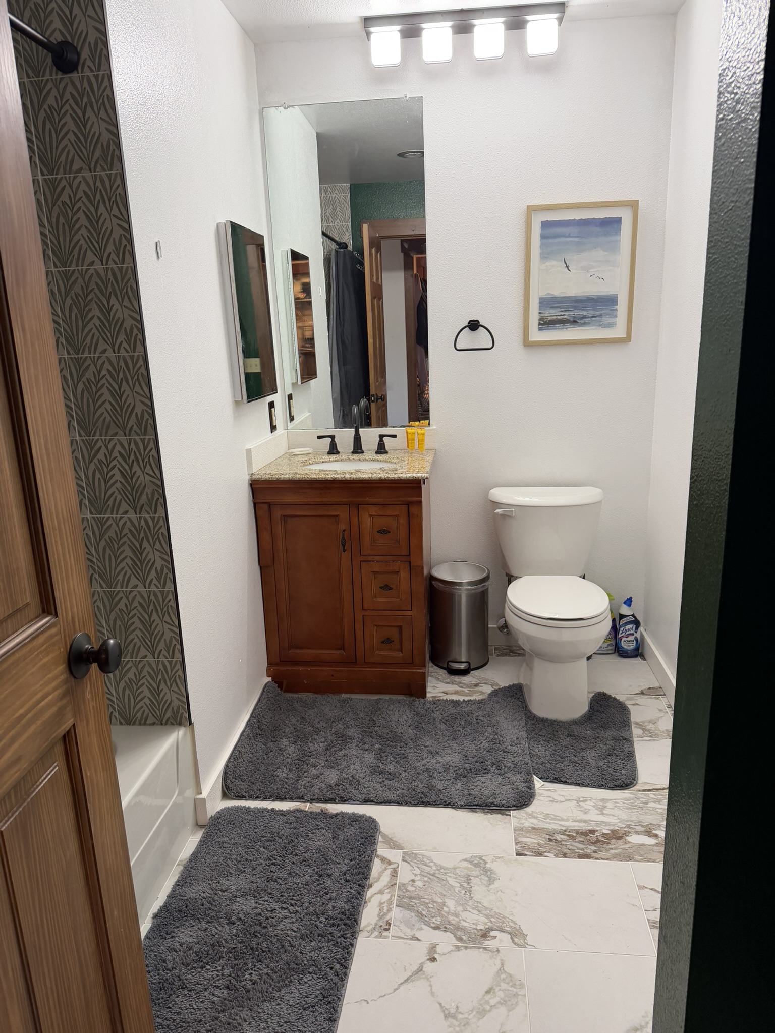 Bright renovated full bathroom with a wood vanity