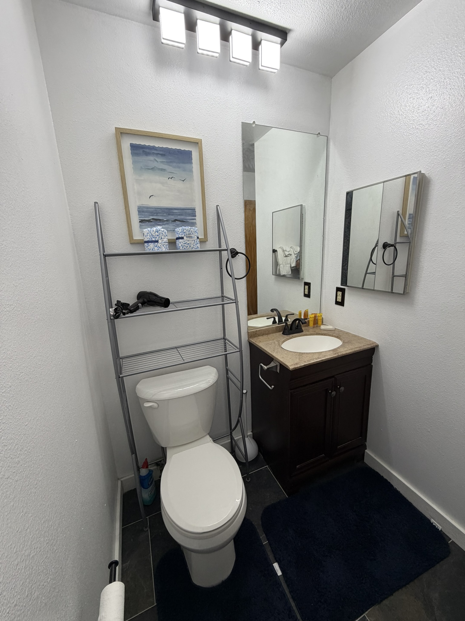 Second bathroom with vanity, mirror and thoughtful storage